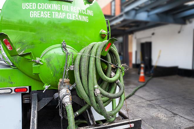 heavy-duty vacuum truck pumping out a grease trap in Milton GA